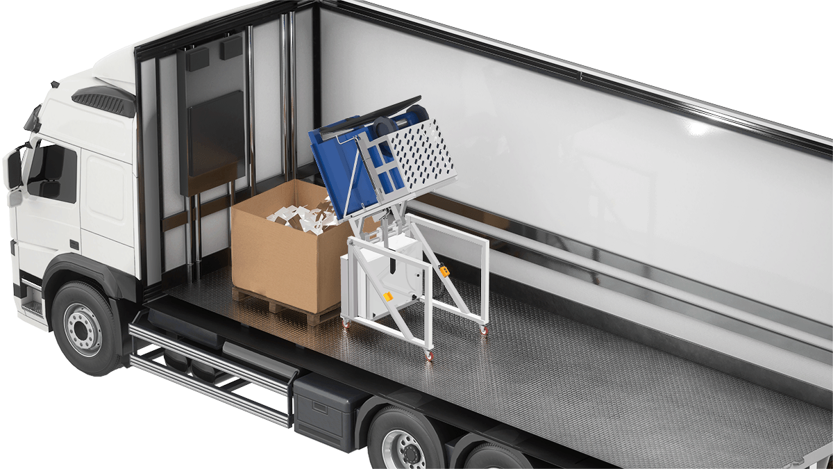 SBT-360_Loading_2026_03_13_1200x675 The Power Knot SBT-360 bin tipper mounted inside a delivery truck, tipping a blue perforated bin into a cardboard gaylord box, illustrating its use in mobile or on-vehicle waste handling operations.